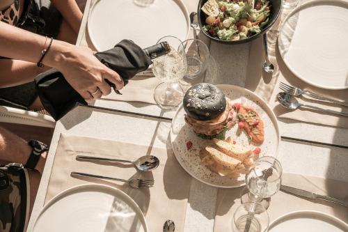a table with a plate of food on a table at Mossa Well Being Hotel - Heated pool in Kato Daratso