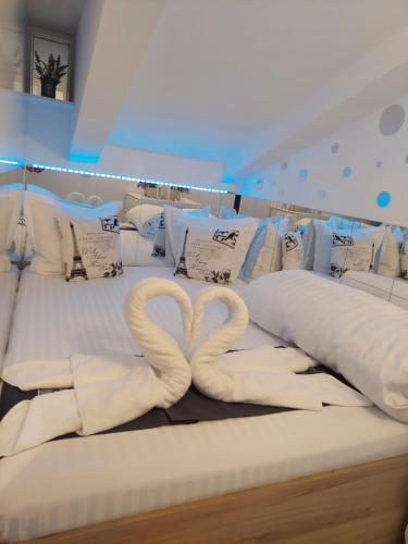 two swans made out of pillows on a bed at Duplex Marquis in Braşov