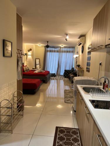 a kitchen and a living room with a couch at Ksl D'Esplanade Studio Apartment's 3 in Johor Bahru
