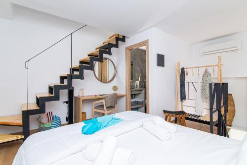 a bedroom with a large bed and a staircase at Nook House in Malia