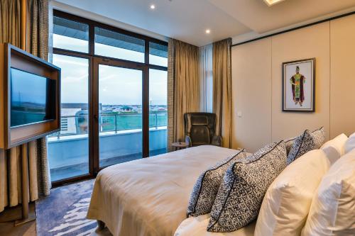 a hotel room with a bed and a large window at Dreamland Golf Hotel Baku in Baku