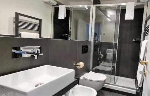 La salle de bains est pourvue d'un lavabo, de toilettes et d'une douche. dans l'établissement Nel Cuore, à Levanto