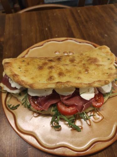 a sandwich on a plate with a toast on top at Podere Casanova in Montespertoli