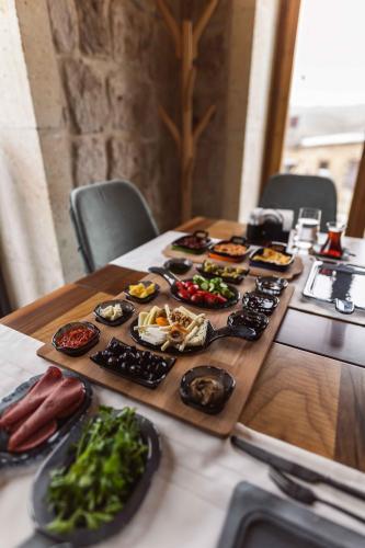 a table with many plates of food on it at Solo Cave Suites in Nevsehir
