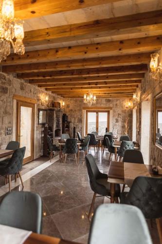 a restaurant with wooden ceilings and tables and chairs at Solo Cave Suites in Nevsehir