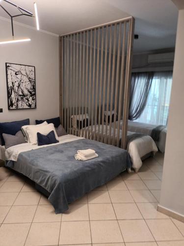 a bedroom with a large bed and a large window at Elite and Style in Preveza