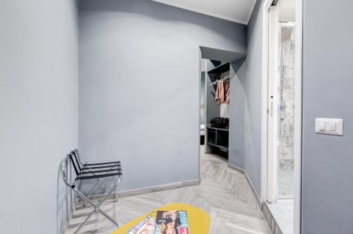 a hallway with a chair and a yellow rug at Ripetta Executive Suites in Rome