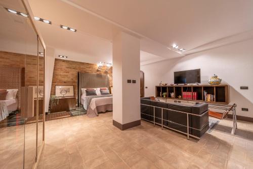 a large room with a bedroom and a bed at Casa Bardi in San Gimignano
