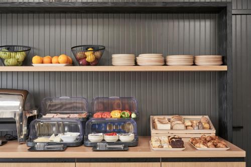 a shelf filled with lots of different types of food at Loizos Stylish Residences in Fira