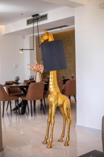 a gold giraffe lamp in a dining room at Villa Indira in Kalithies