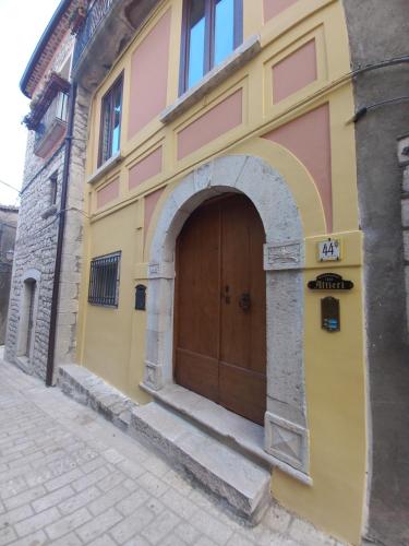 a building with a wooden door on a street at Casa Altieri in Cusano Mutri