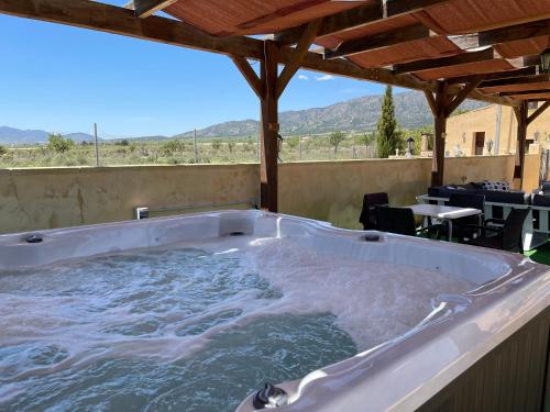 a jacuzzi tub on a patio with a table at Grapevine Manor in Monóvar