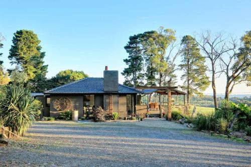 a house with a gravel driveway in front of it at Gorgeous villa 10 acre of land in Menzies Creek