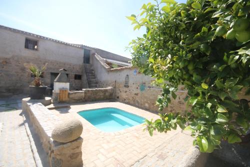 - une piscine dans une cour à côté d'un bâtiment dans l'établissement Casa de pueblo Montenegro, à Zalamea de la Serena