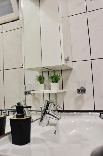 a bathroom with a sink and a mirror at Trsteno Dream House in Trsteno