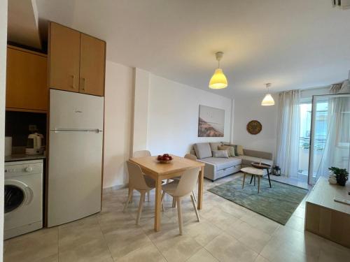 a kitchen and living room with a table and a couch at lovely apartment beside the Alcossebre beach in Alcossebre