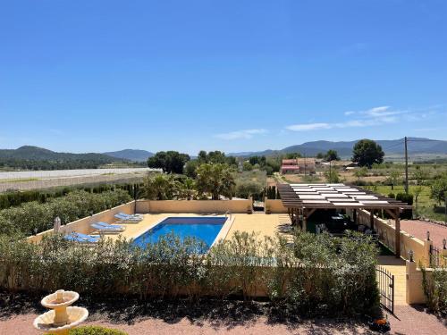 a villa with a swimming pool in the desert at Grapevine Manor in Monóvar