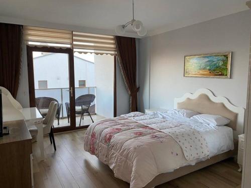 a bedroom with a bed and a desk and a window at Private villa in Yalova/Thermal, with heated pool in Termal