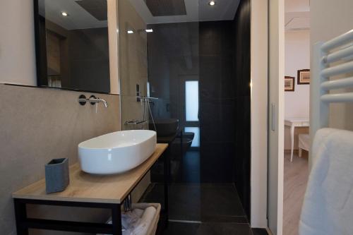 a bathroom with a white sink and a mirror at Villino Micol camere a due passi dal mare in Marina di Carrara