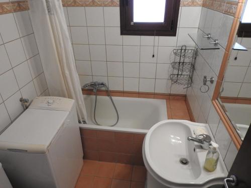 a bathroom with a sink and a bath tub at Konstantinos' Nikiti Apartment in Nikiti