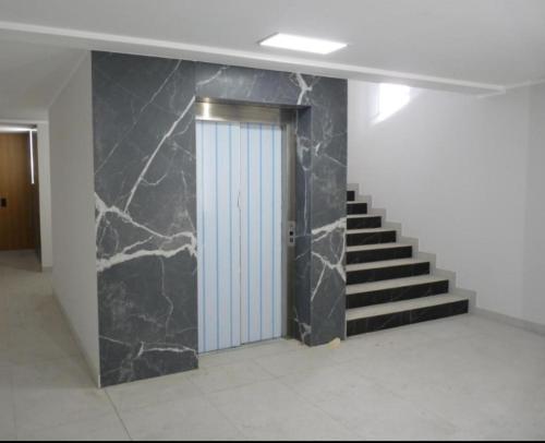 a hallway with a door and stairs in a building at Apartament w sercu Ciechocinka in Ciechocinek