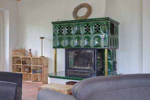 a living room with a green cabinet with a tv at Landhaus Schwerin in Schwerin