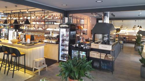 a bar in a restaurant with a lot of alcohol at Hotel Marino in Jūrmala