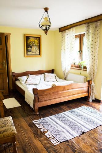 a bedroom with a large wooden bed in a room at Zielony Ruczaj in Cisna