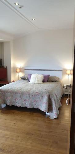 a bedroom with a bed and two lamps on the floor at Casa restaurante O Pitès in Alfaião