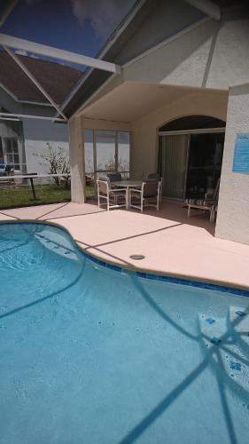 a swimming pool in front of a house at Florida Villa in Kissimmee