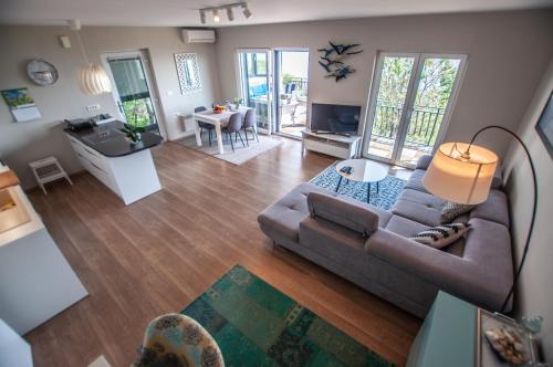 a living room with a couch and a table at Sea View Apartments Debeli Rtič in Ankaran