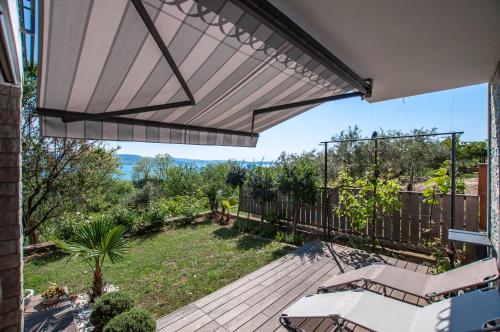 an open patio with a view of a yard at Sea View Apartments Debeli Rtič in Ankaran