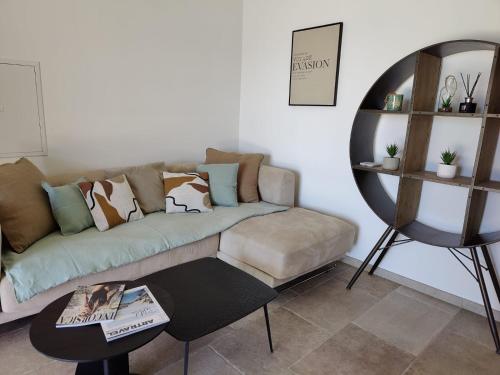 a living room with a couch and a table at Résidence Licciola in Propriano