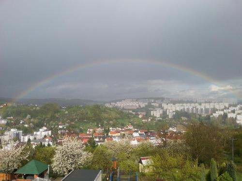 a view of a city with a rainbow in the sky at Penzion ALICE in Zlín