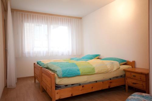 a small bedroom with a bed with a window at Alpbachstrasse 4, Meiringen in Meiringen