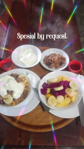 a table with three plates of food on it at Wahyu Homestay 1 in Nusa Lembongan