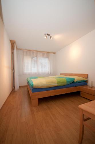 a bedroom with a bed in a room at Alpbachstrasse 4, Meiringen in Meiringen