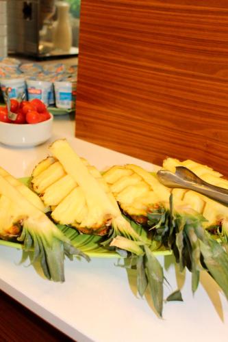a plate of cheese and other food on a counter at Hotel Cristina in Grado
