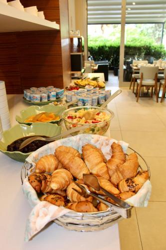 a buffet with several plates of food on a table at Hotel Cristina in Grado
