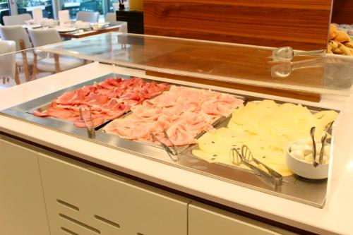 a buffet with many different types of food on a counter at Hotel Cristina in Grado
