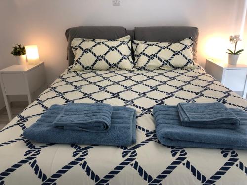 a bed with blue towels sitting on top of it at Blue Escape (Beach Seafront) in Larnaka