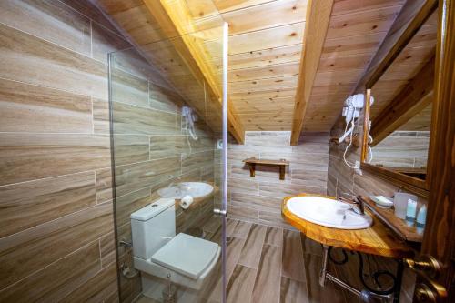 a bathroom with a toilet and a sink at Berati Castle Hotel in Berat