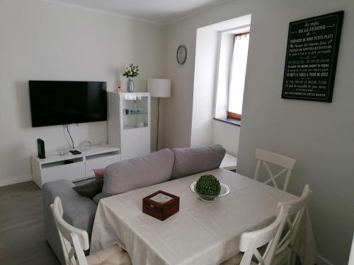 a living room with a table and a couch at Miragaia Star Apartments in Angra do Heroísmo