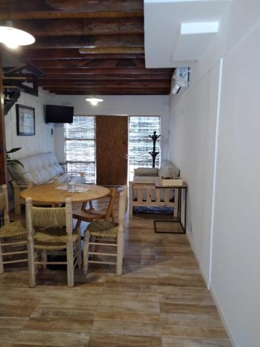 a dining room with a wooden table and chairs at El Jacal de San Pedro in San Pedro
