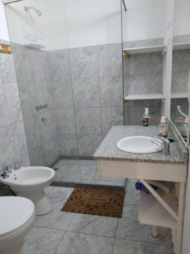 a bathroom with a shower and a sink and a toilet at El Jacal de San Pedro in San Pedro