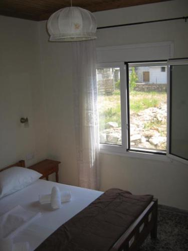 a bedroom with a bed and a window at George house in Theologos