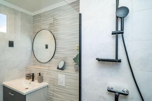 a bathroom with a sink and a mirror at M2 Apartment Dubrovnik in Dubrovnik