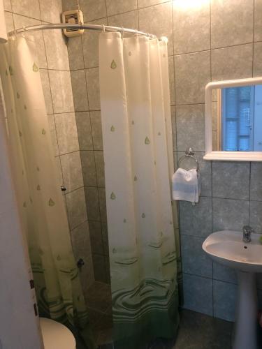a shower with a shower curtain in a bathroom at Apartmani Sunce in Bar