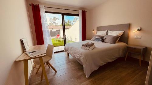 a bedroom with a bed and a large window at Villa moderne avec spa à Montalivet in Vensac