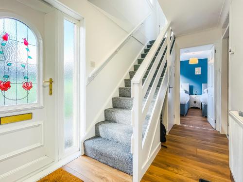 a staircase in a house with a window at Cheerful Stays - Livingston - 4 Bedroom 3 Bath home in Livingston
